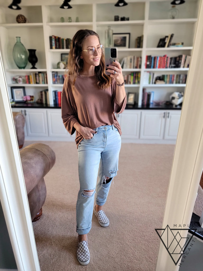 jenise models a cocoa brown tunic with ripped jeans
