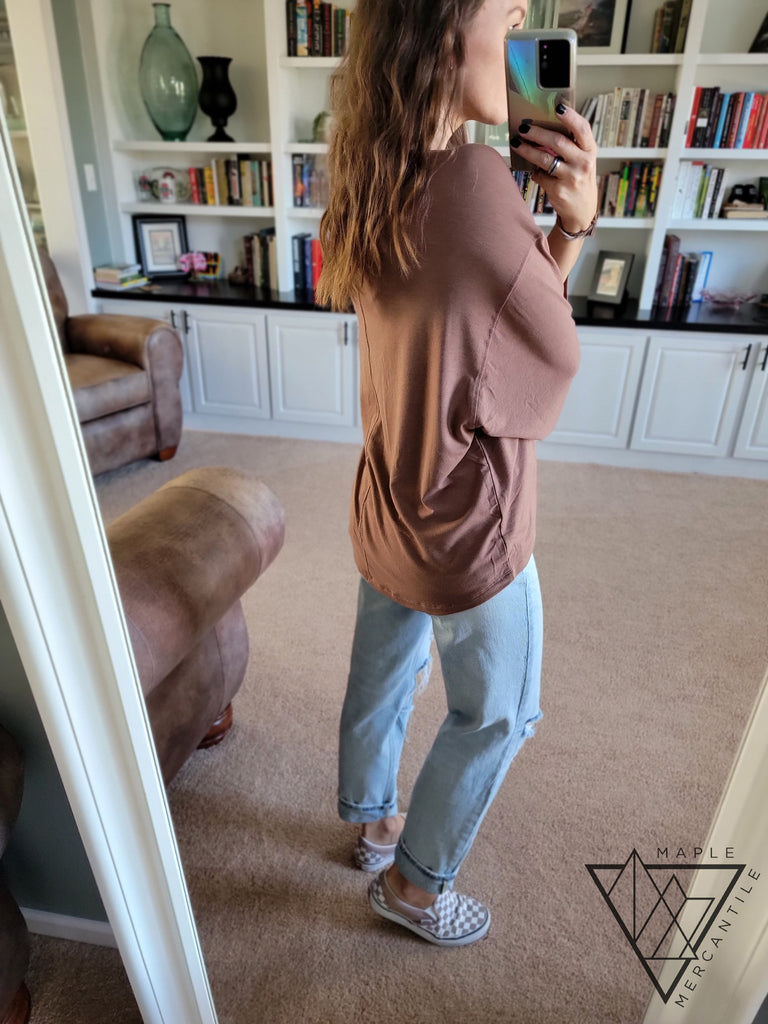 backside view of a hi-lo tunic in cocoa color with light blue jeans